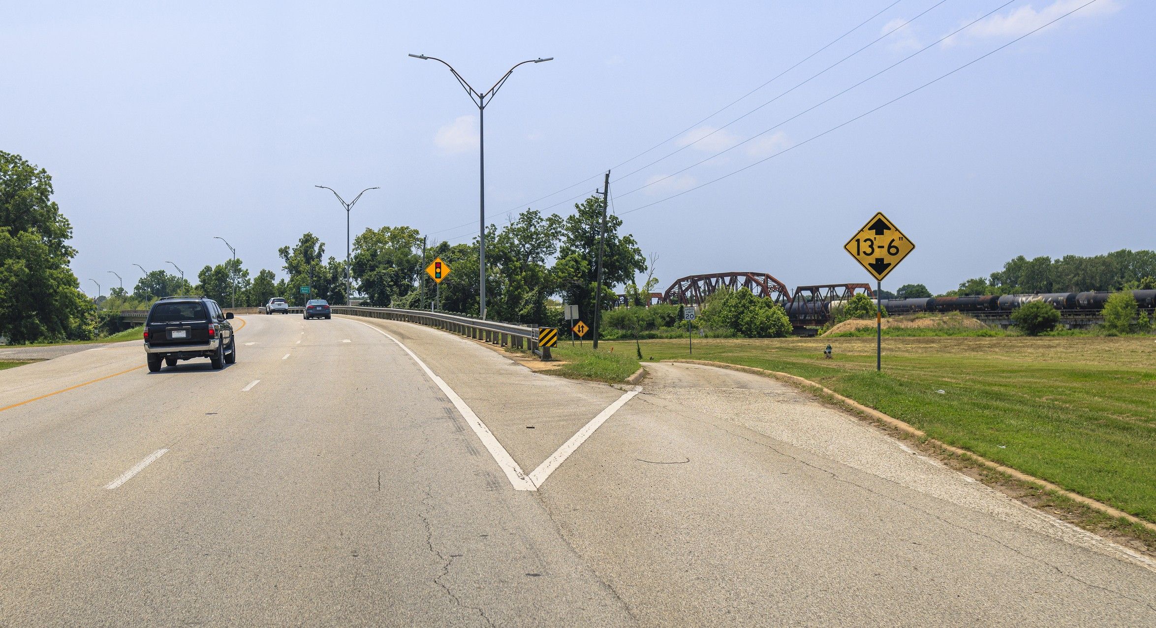 A fork in a highway with the right side showing a low clearance sign.