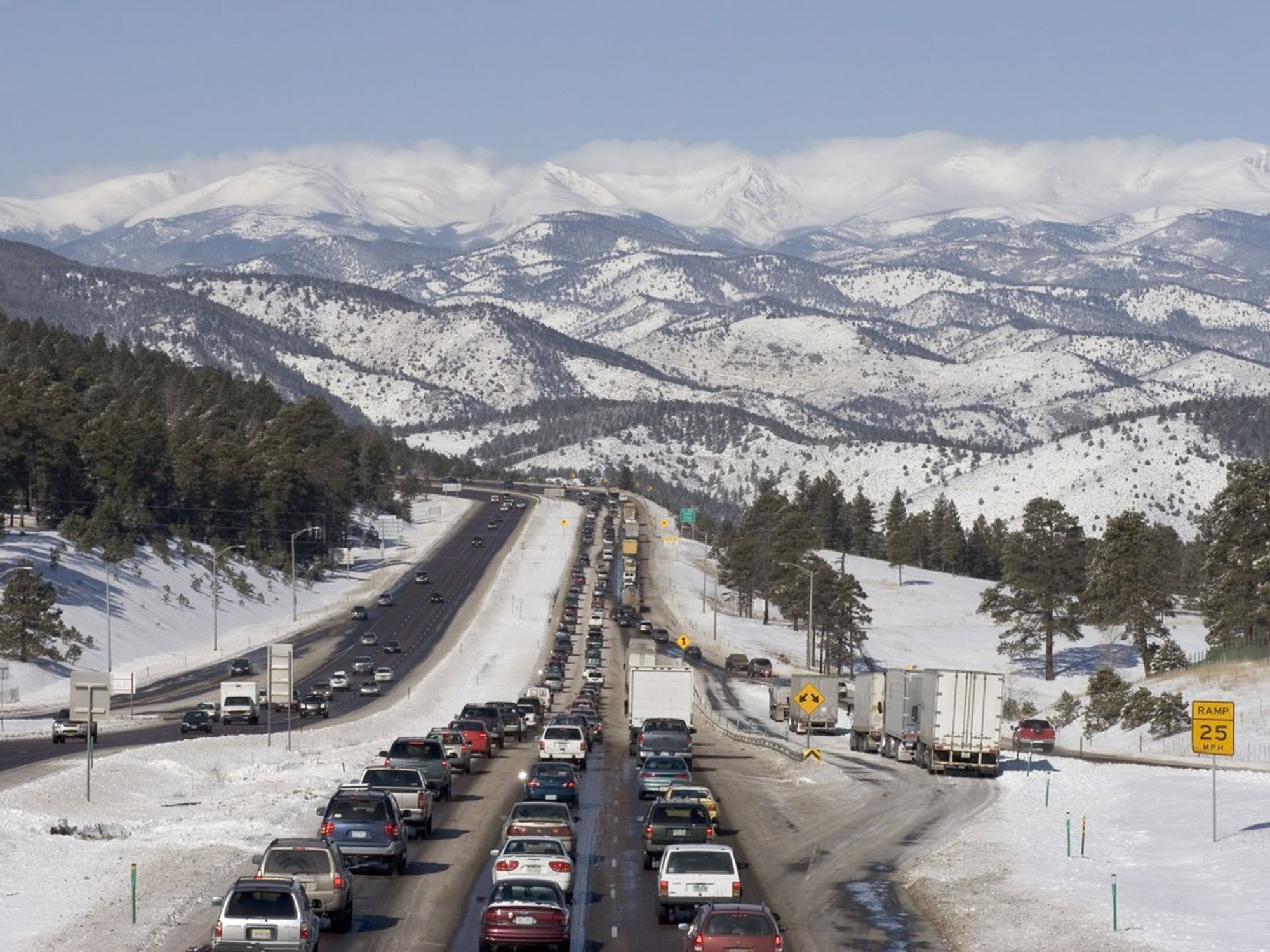 A holiday traffic jam in front of snowy mountains.