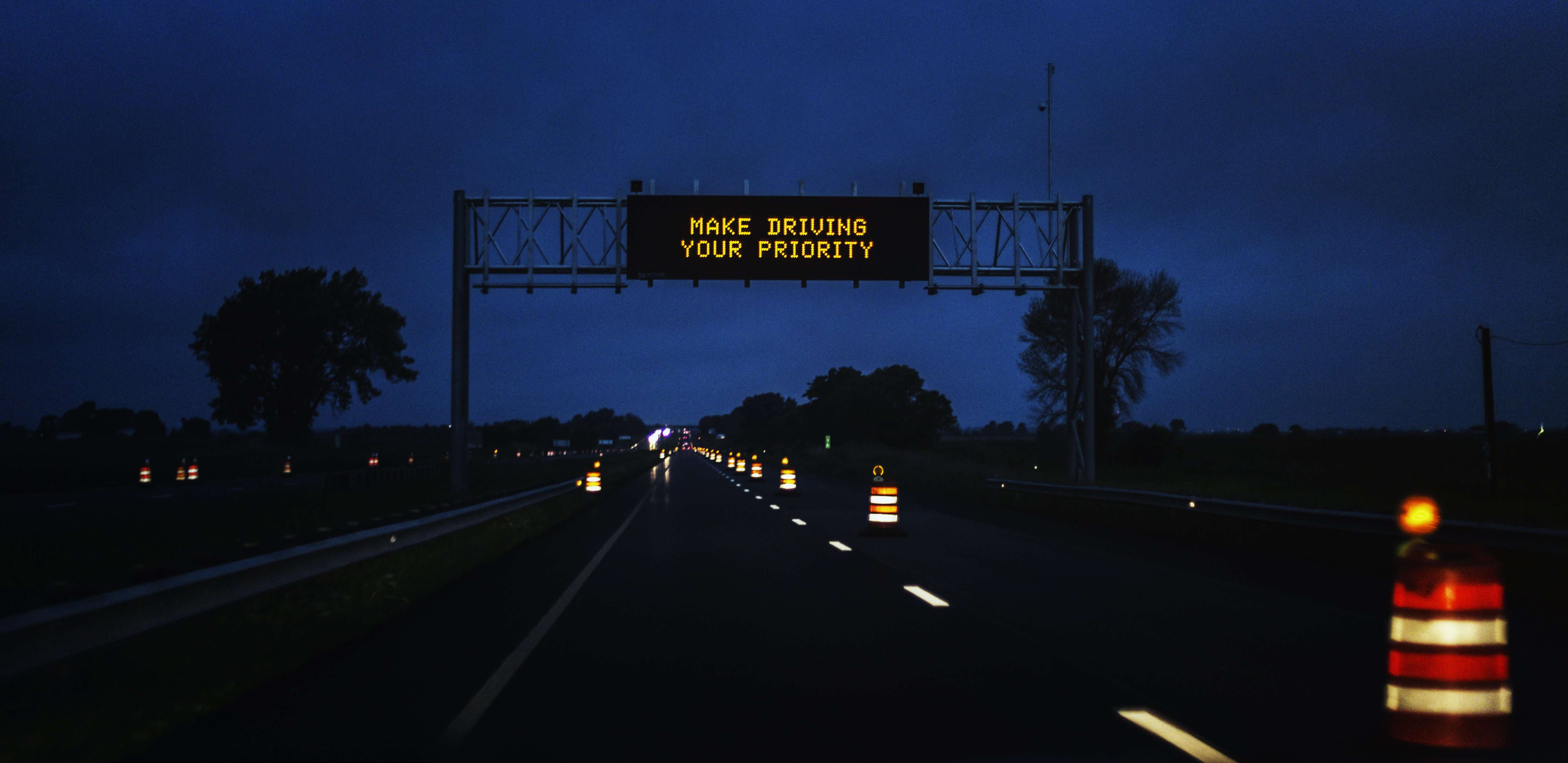 A Make Driving Your Priority highway sign