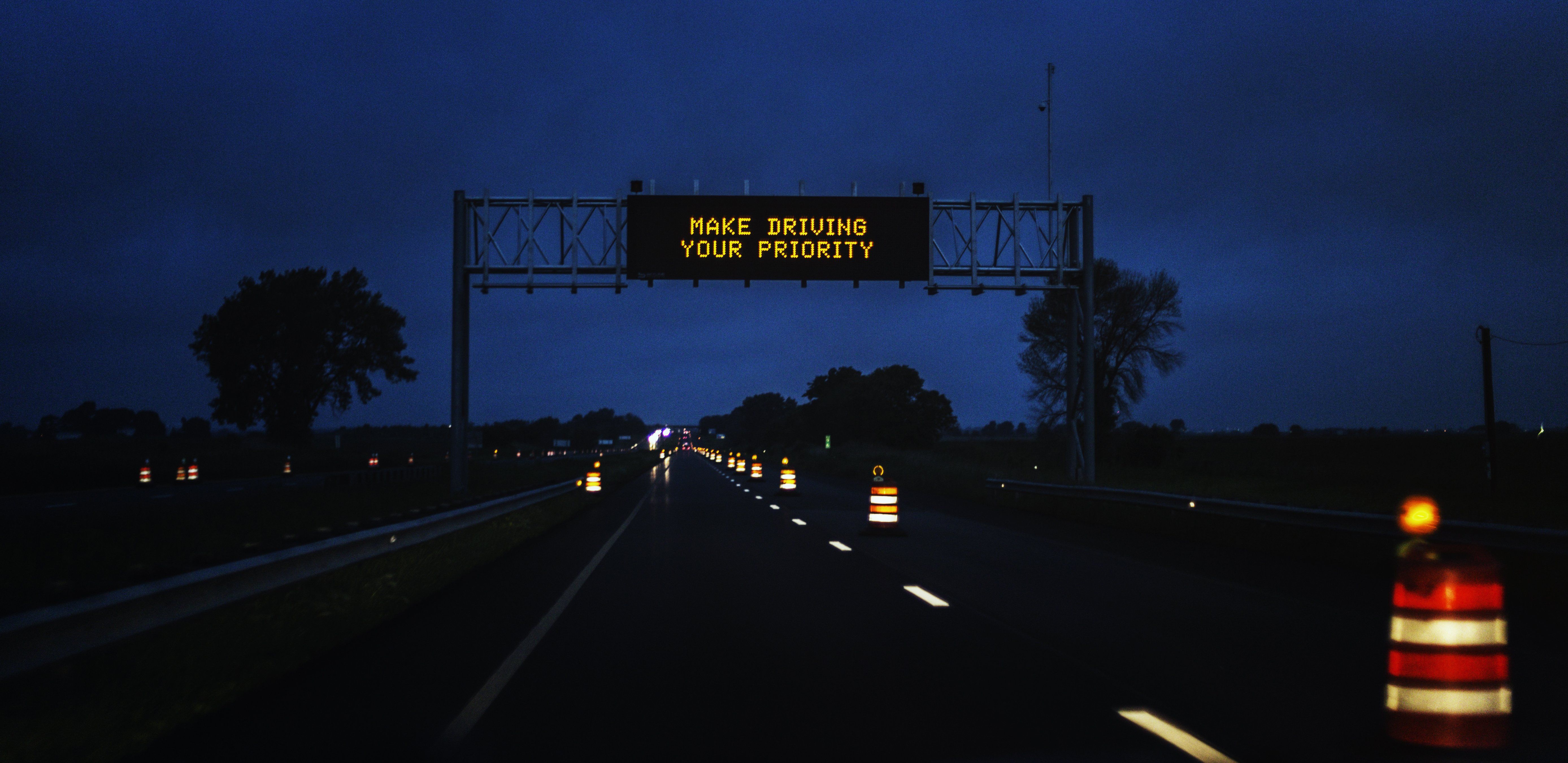 A Make Driving Your Priority highway sign