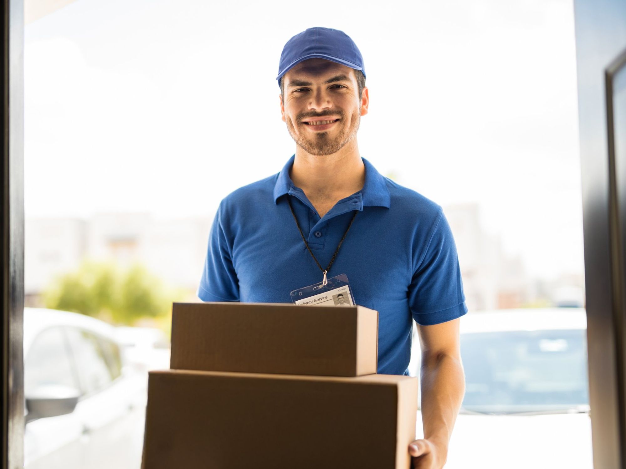 A man delivers boxes to a business.