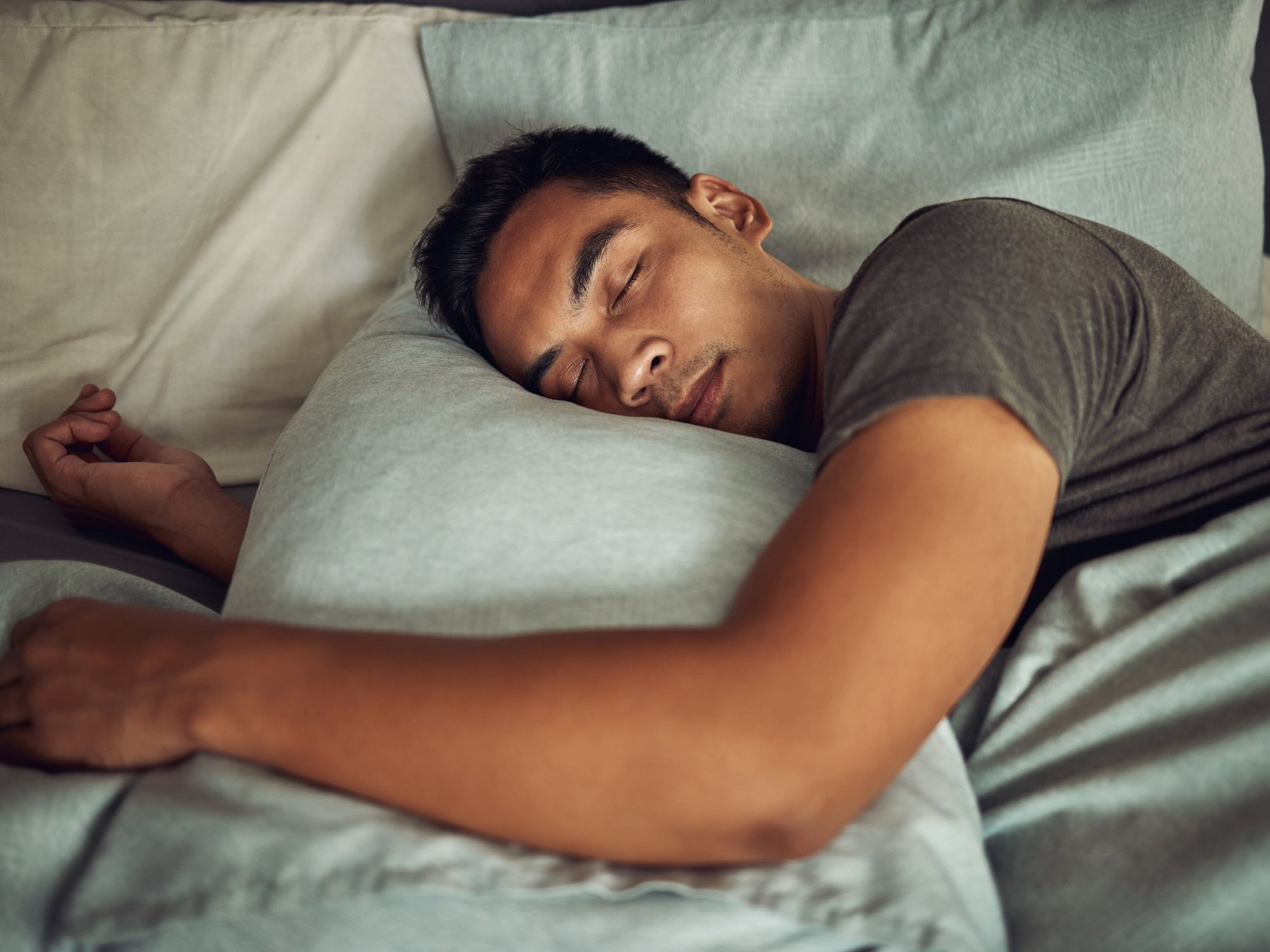 A man sleeping on a grey pillow