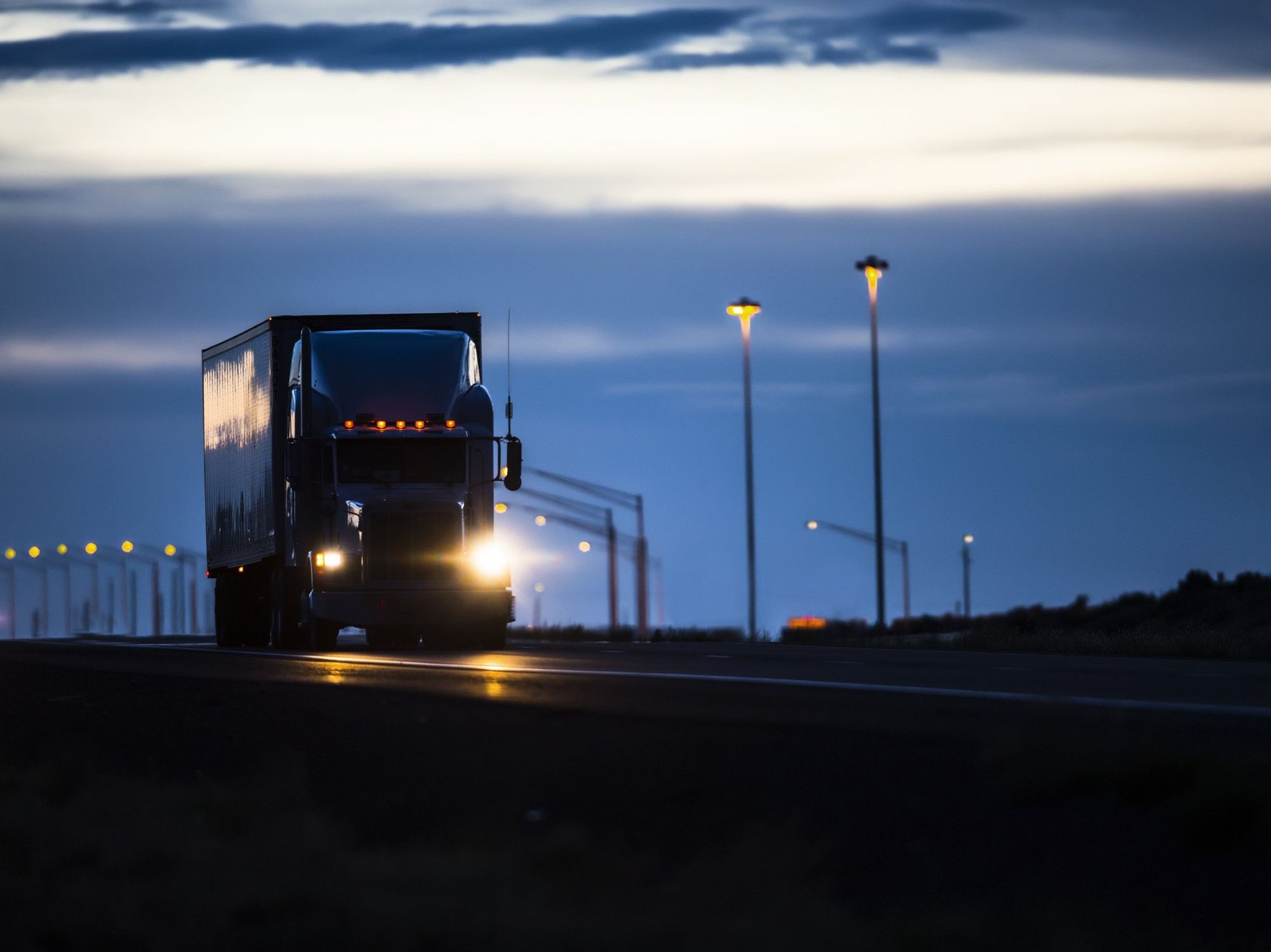 A semi-truck driving at night