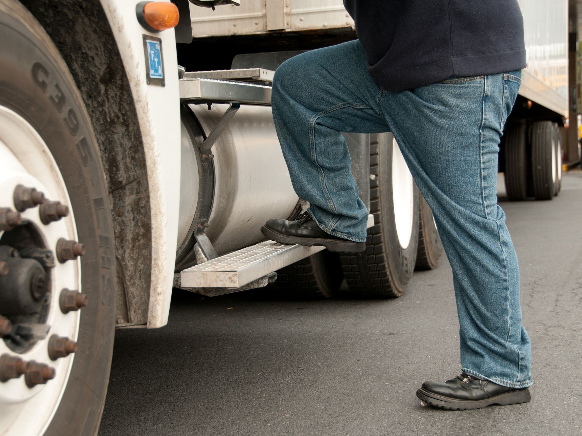 A truck driver steps into a semi truck