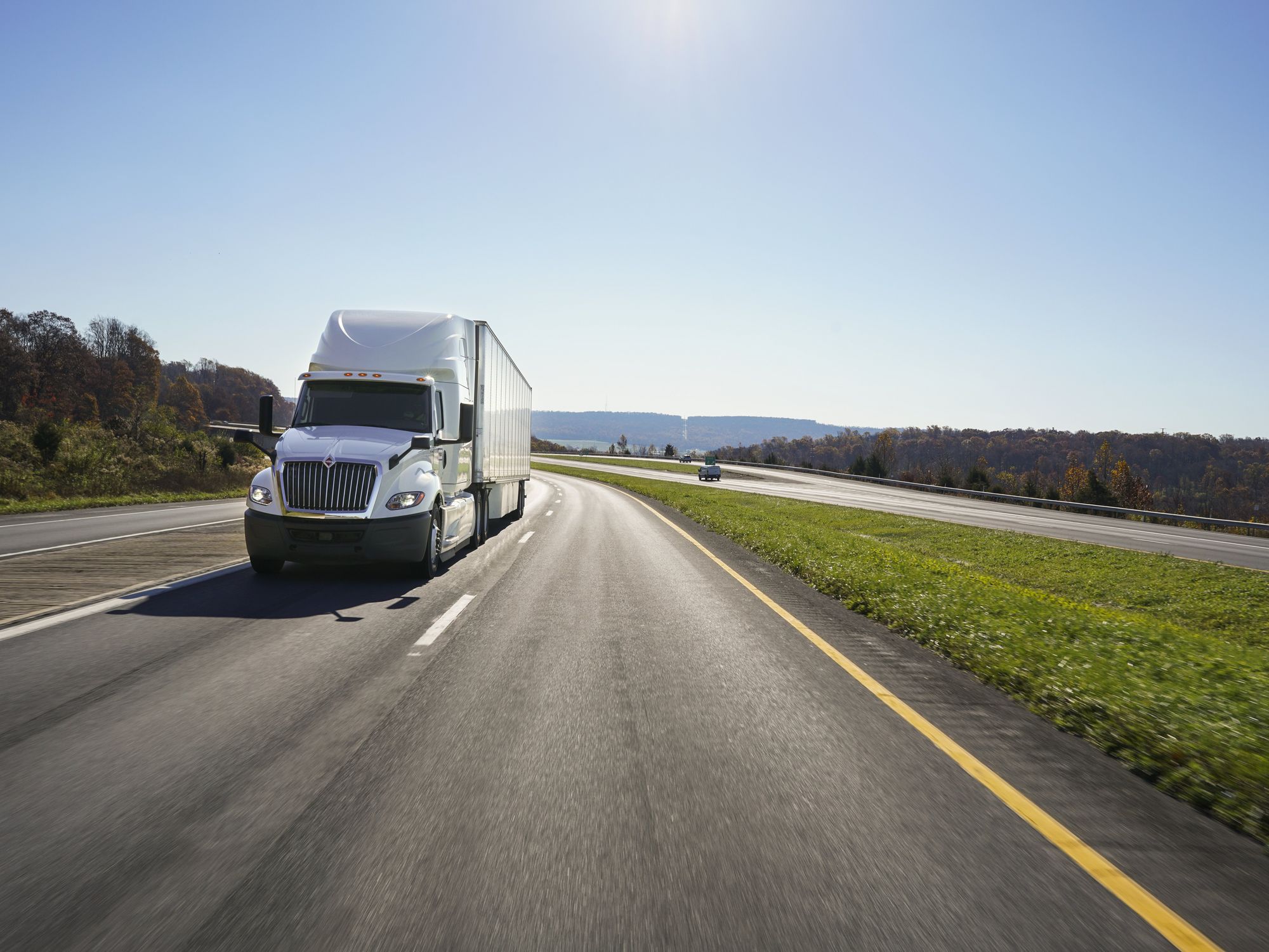 A white Penske semi on the road