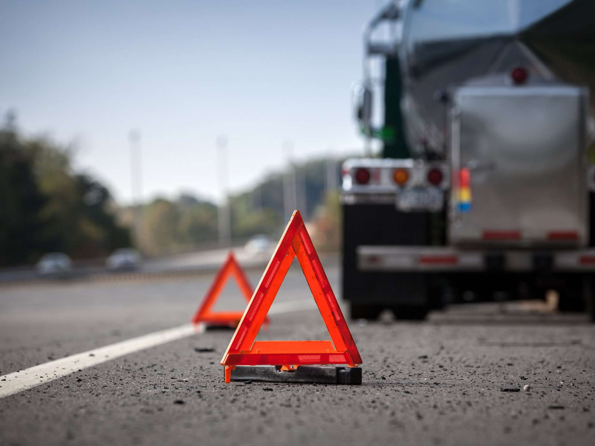 Caution triangles on the road warning of a stopped truck