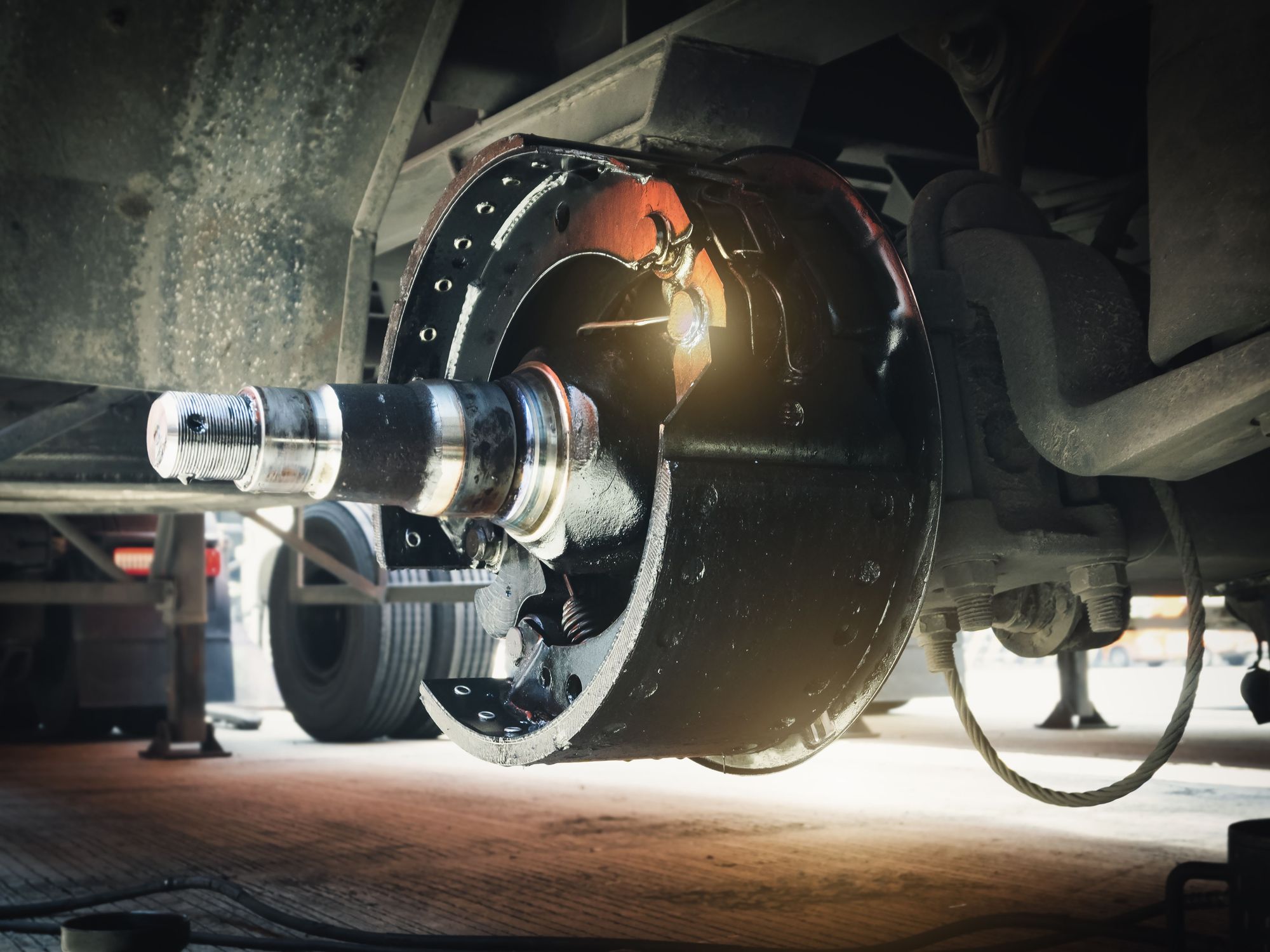 Close-up of break drums and pads on a semi-truck wheel.