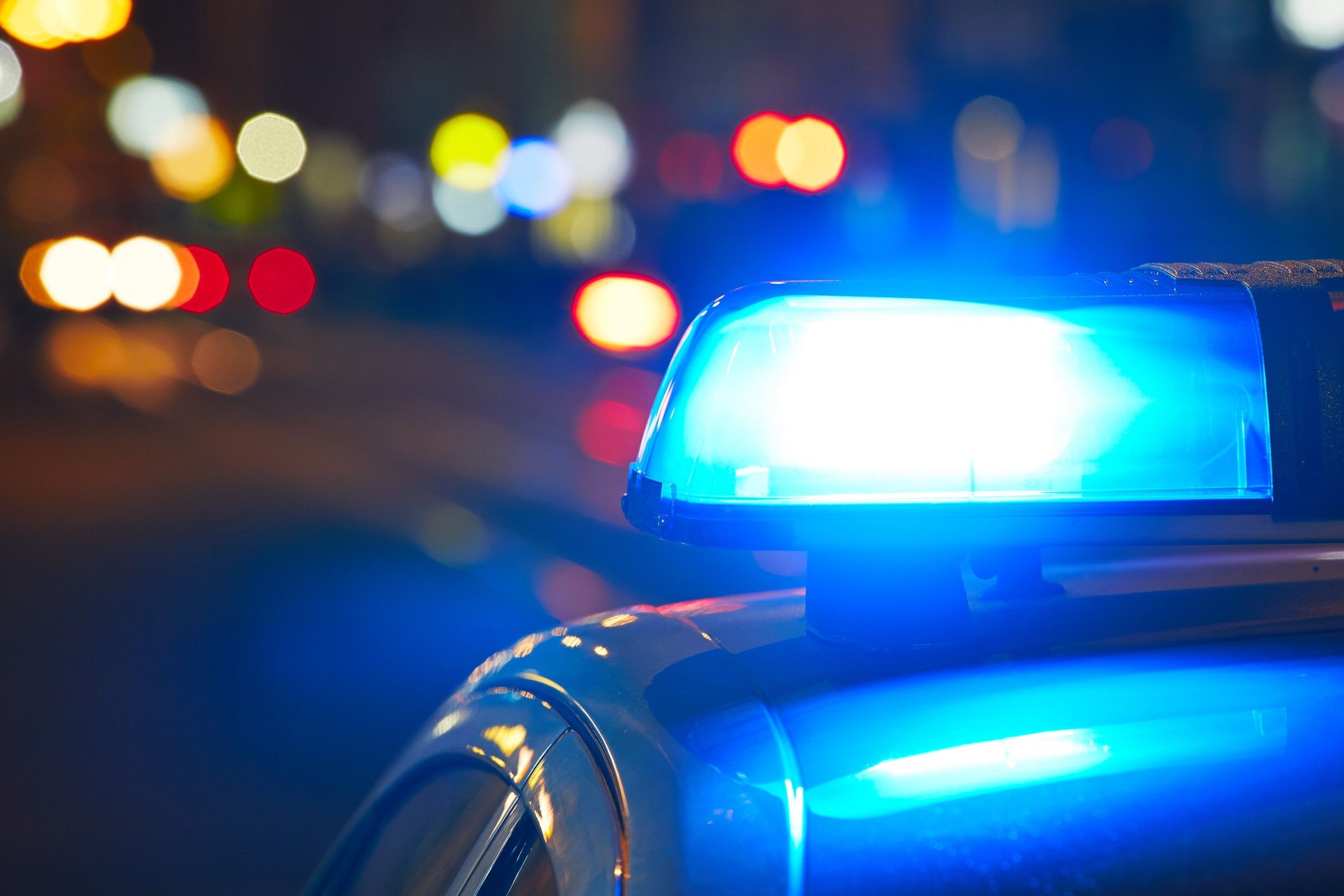 Closeup photo of blue police lights on top of a car.
