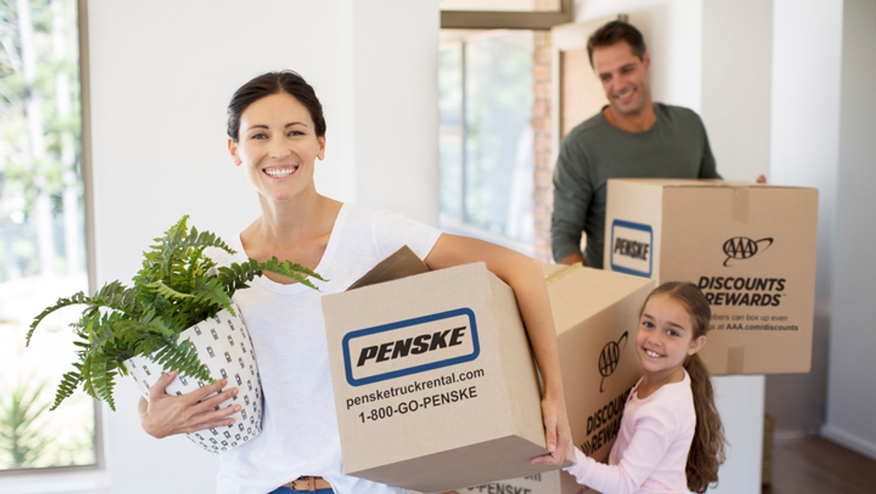 family carrying moving boxes