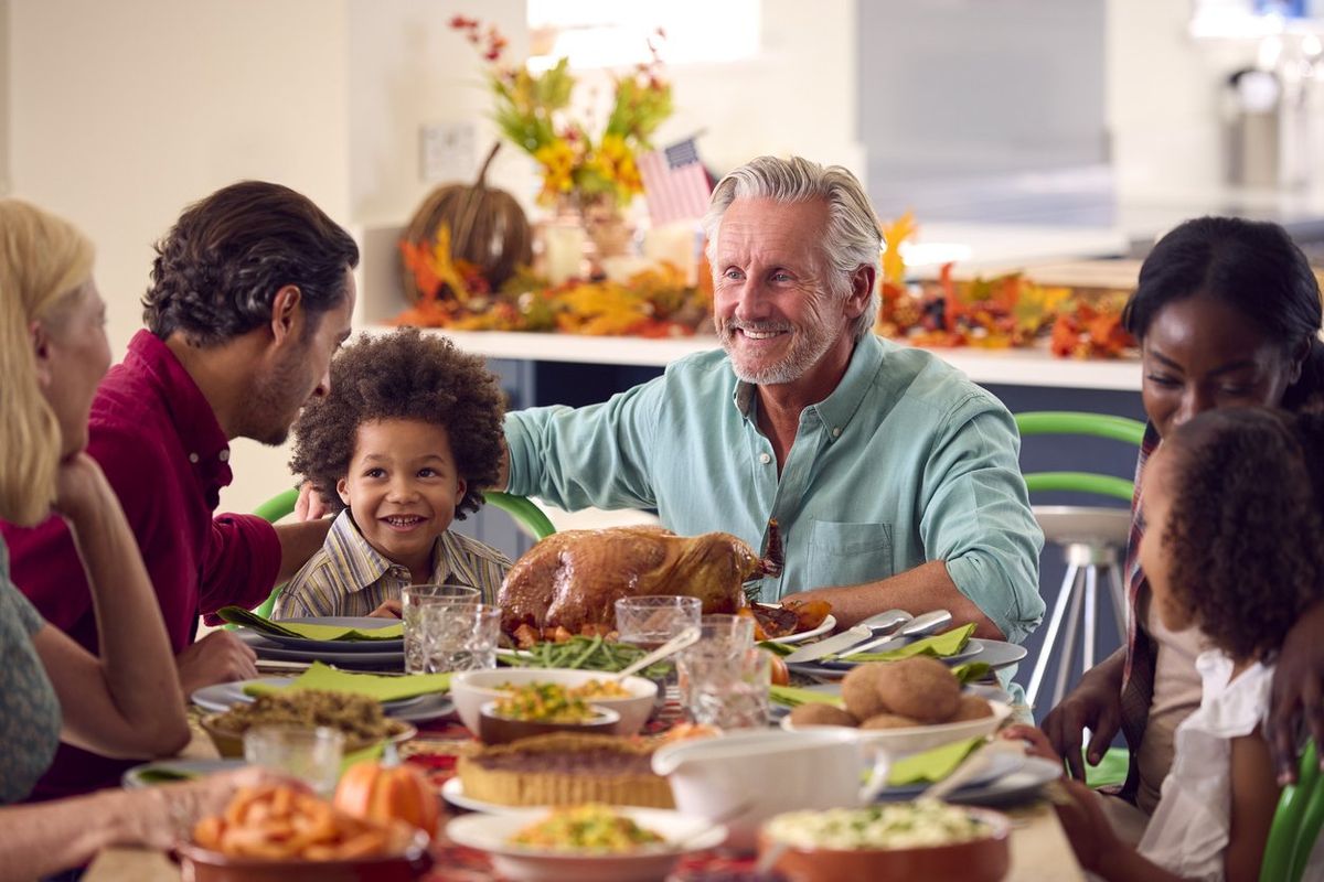 Family gathered around the table for Thanksgiving dinner.