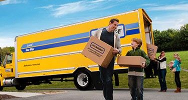 Family unpacking a moving truck