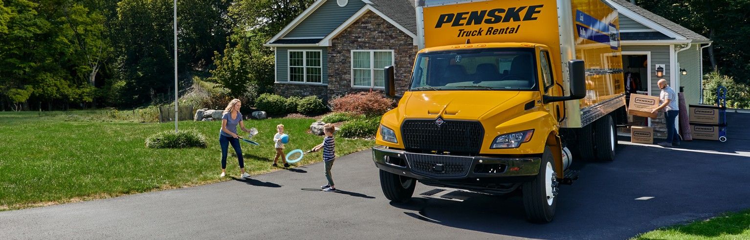Family with Penske moving truck
