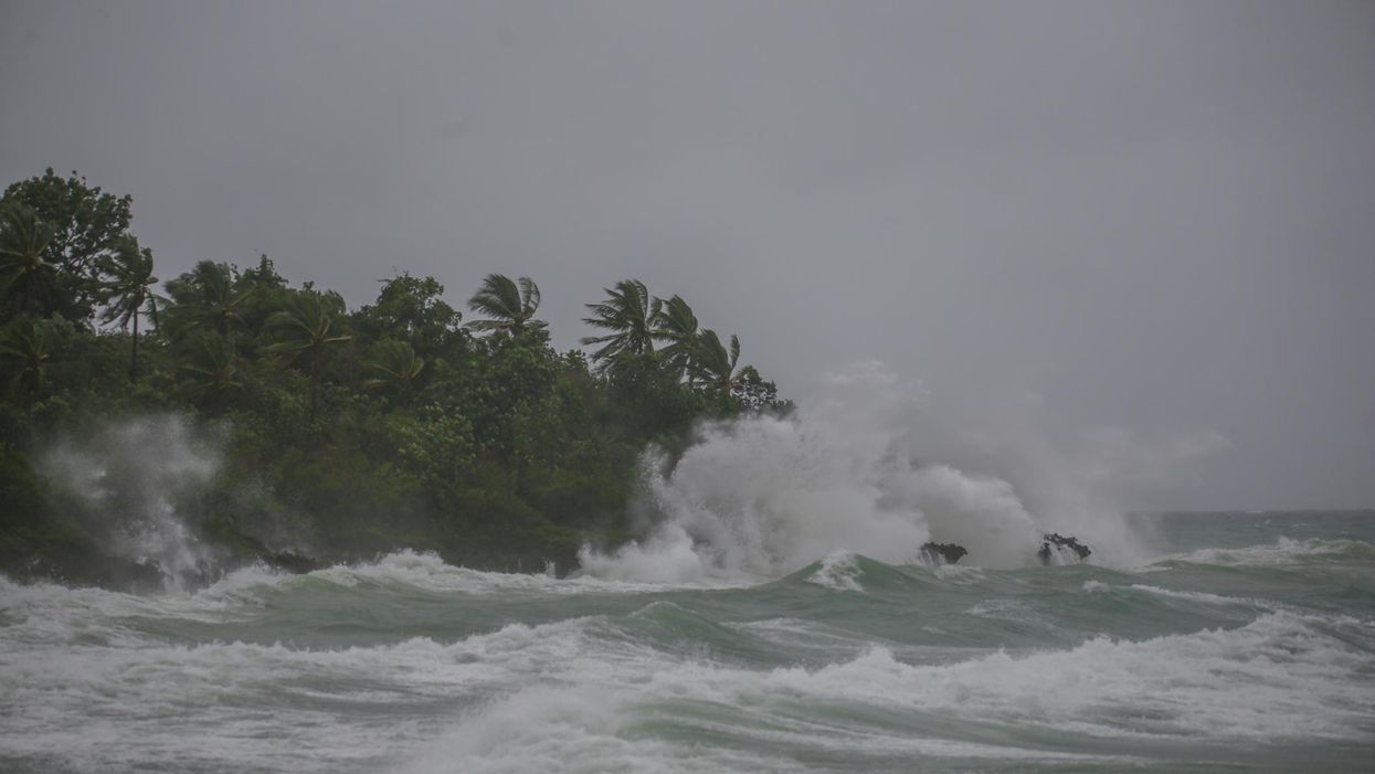 High tides crash on a tropical shore during a hurricane.