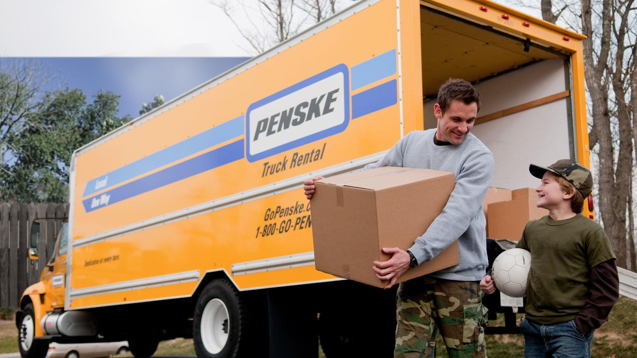 Military father and son unloading a Penske truck from a recent move.