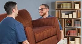 Moving laborers carrying furniture