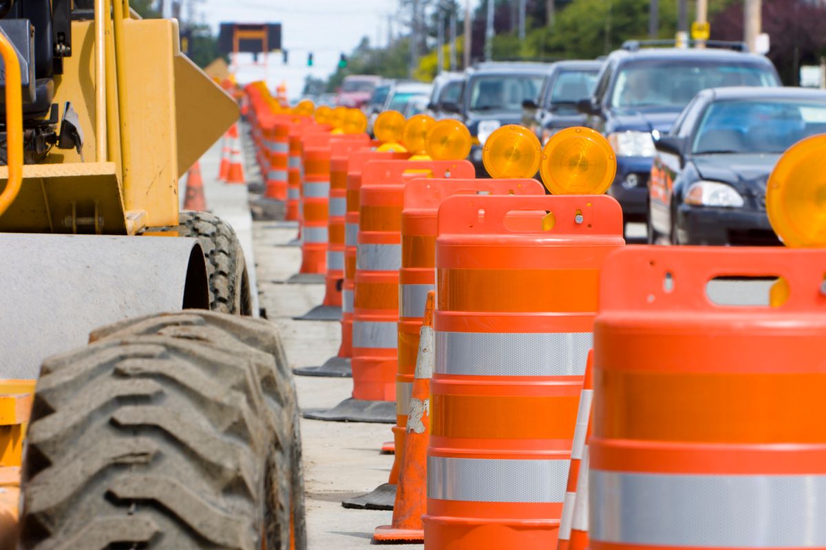 Orange cones marking a work zone on the street.