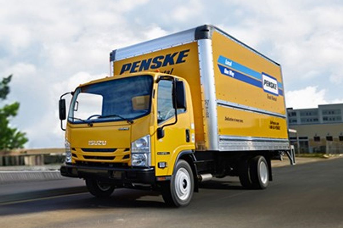 Penske cabover truck on a tree-lined highway
