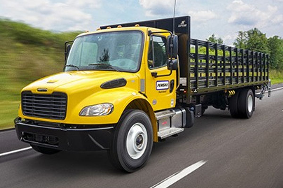 Penske flatbed truck (CDL required) on a tree-lined road
