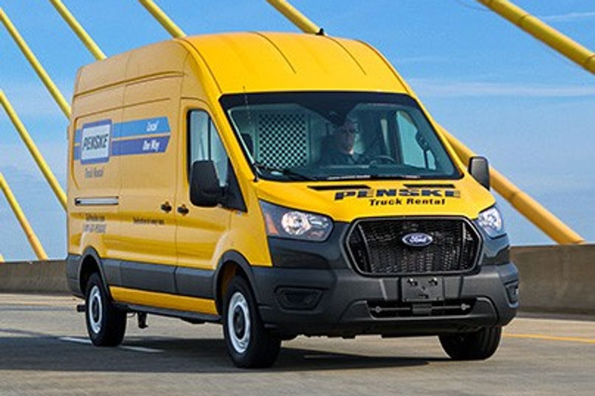 Penske high-roof cargo van on a highway crossing a suspension bridge