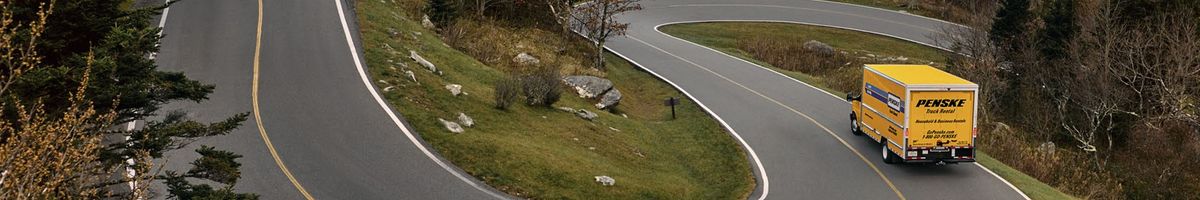 Penske moving truck on a curvy road