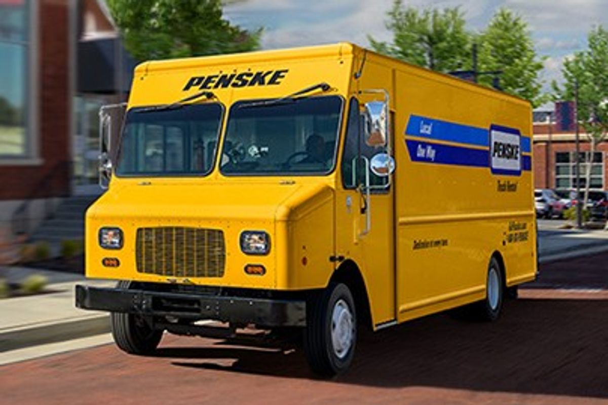 Penske step van traveling along a residential street