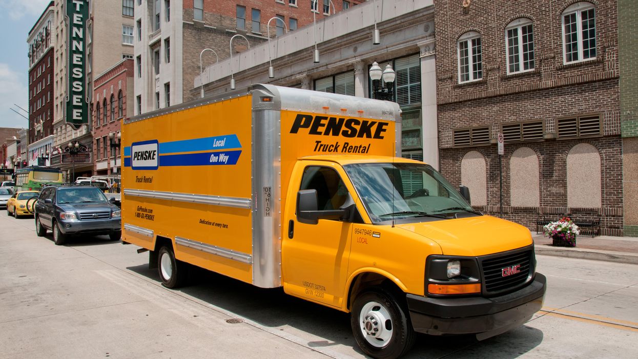 Penske truck driving through city