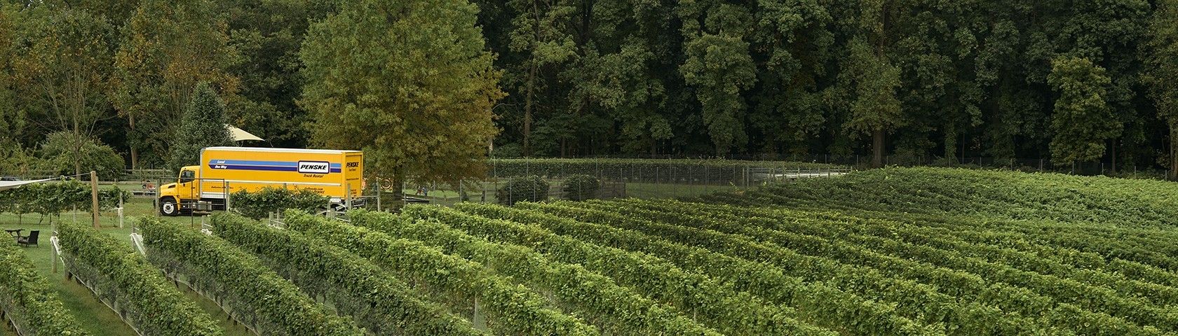 Penske truck driving through farm