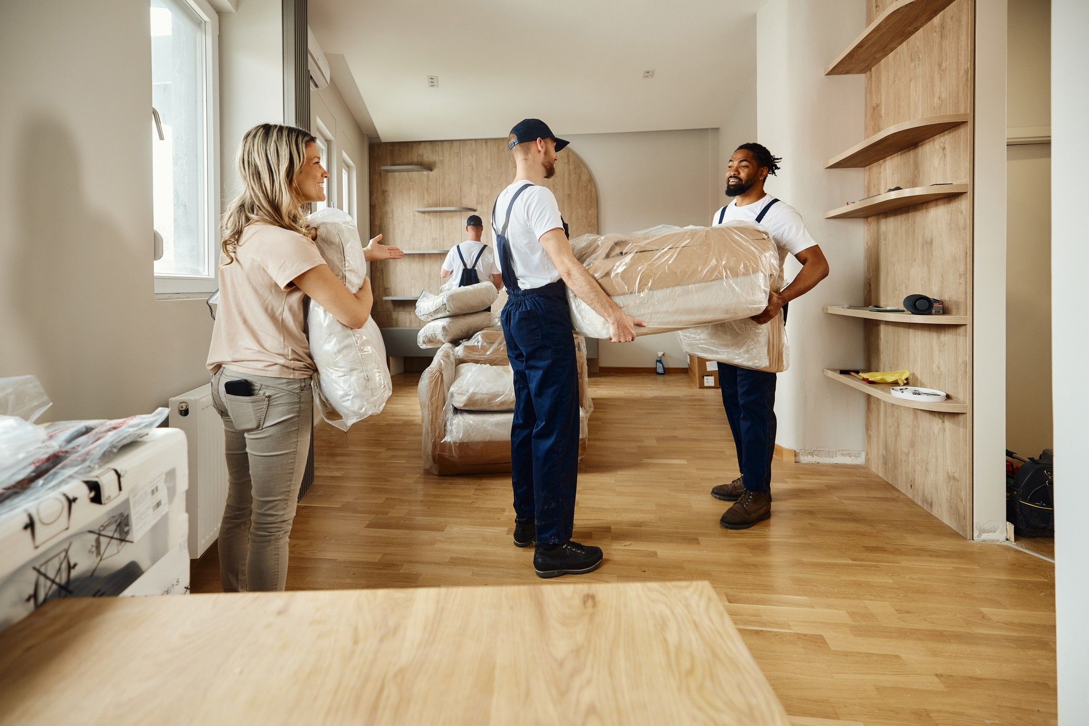 Professional movers in move furniture out of an apartment.