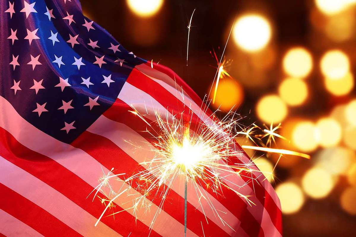 Sparkler with an American Flag in the Background