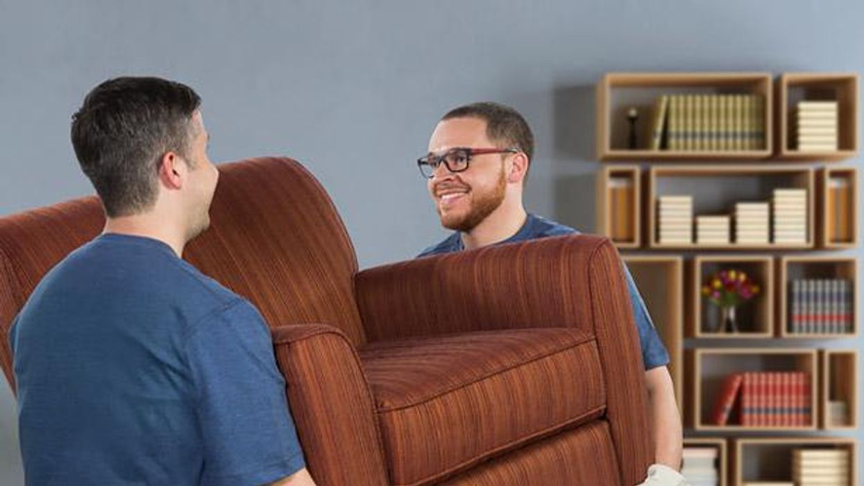 Two men lifting a chair