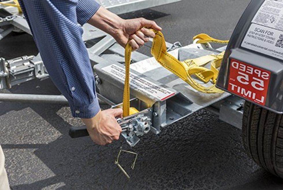User connecting a tow dolly