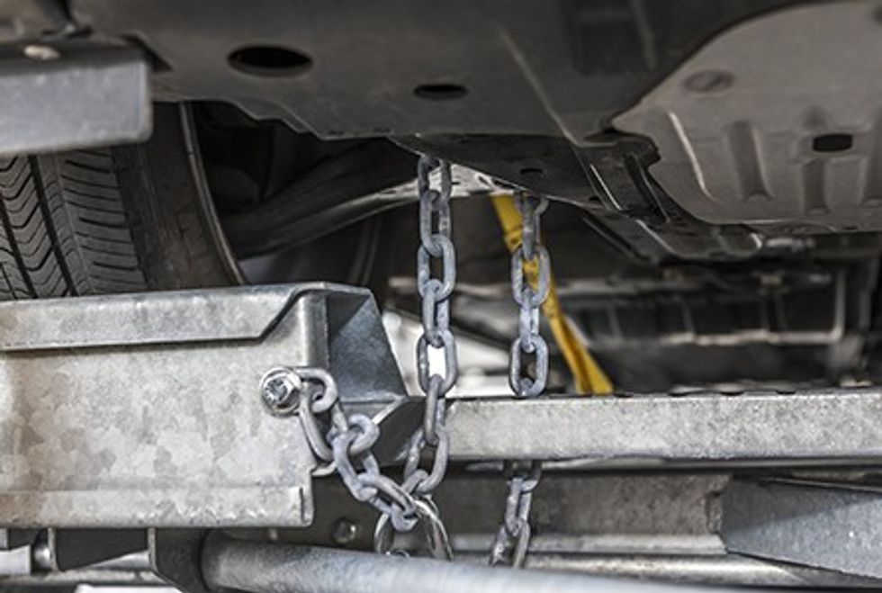 User connecting a tow dolly