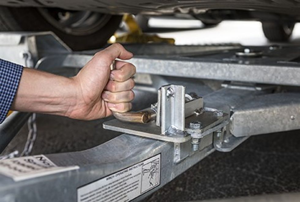 User connecting a tow dolly