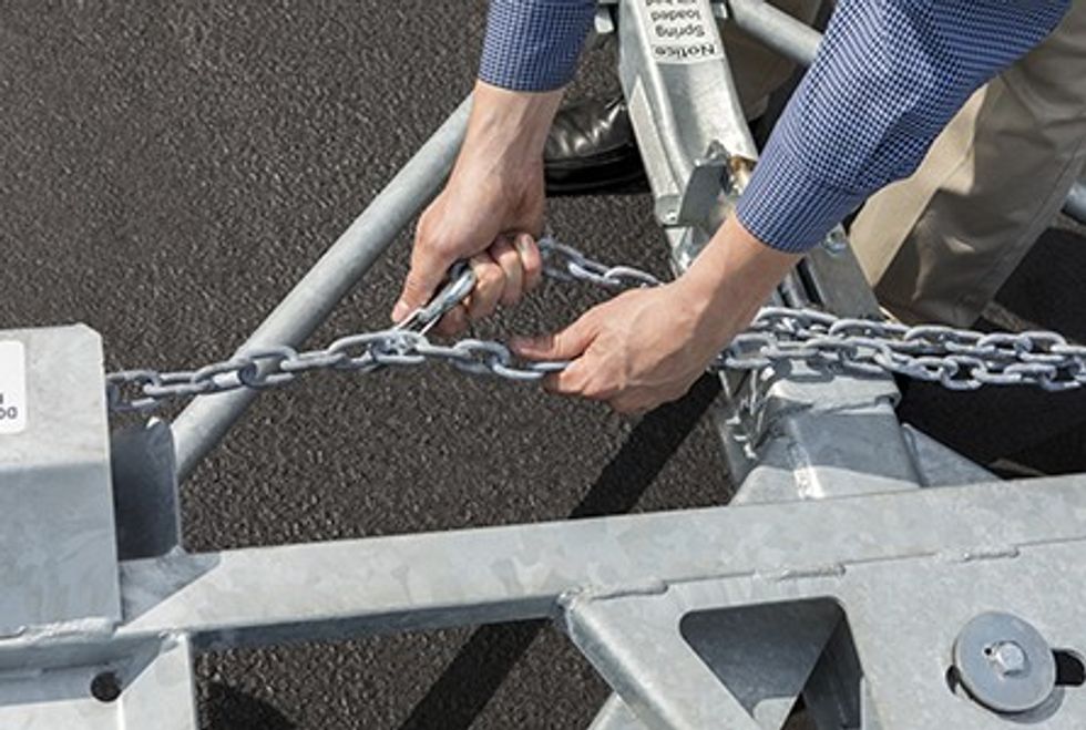 User connecting a tow dolly