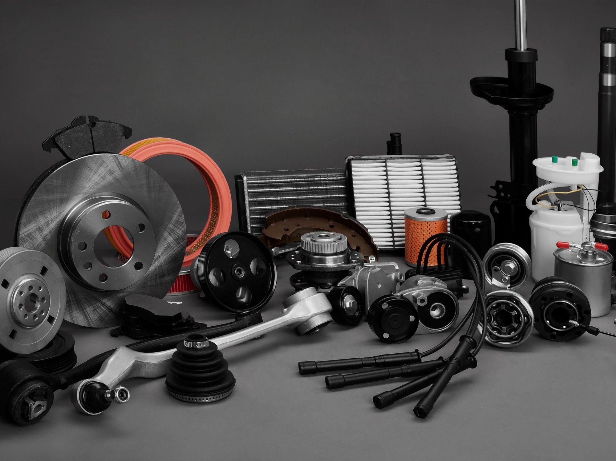 Various car parts displayed on a grey background.