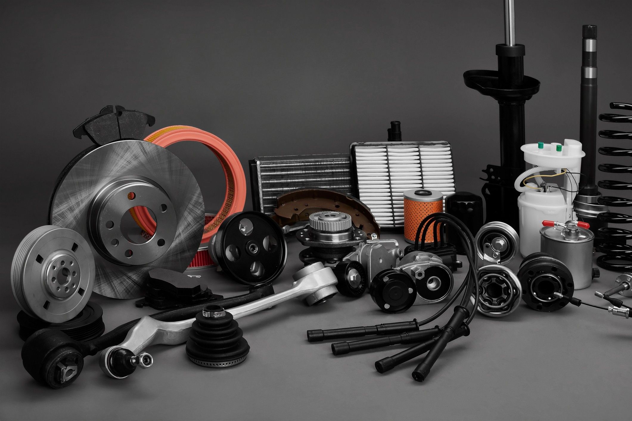 Various car parts displayed on a grey background.