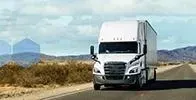 White tractor trailer on a desert road