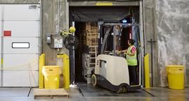 Woman on forklift working in warehouse